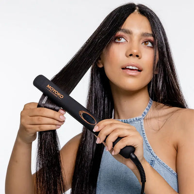 A woman using the Moyoko Classic Styler with ceramic plates and negative ions
