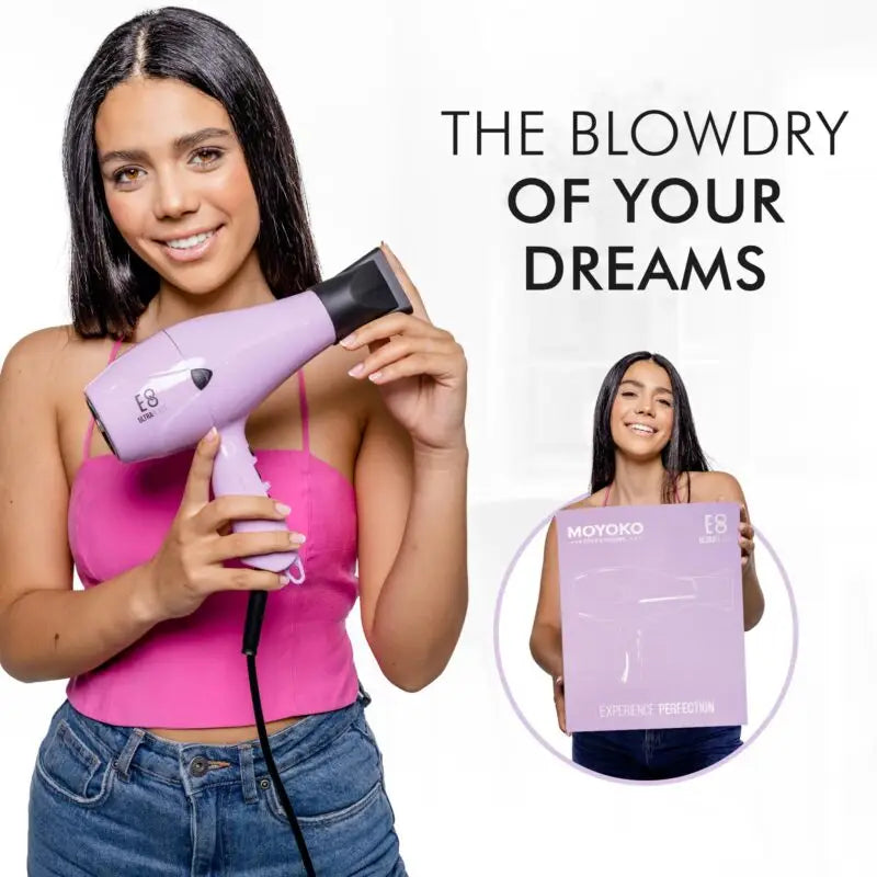 Purple hair dryer held by a smiling woman in a pink top.