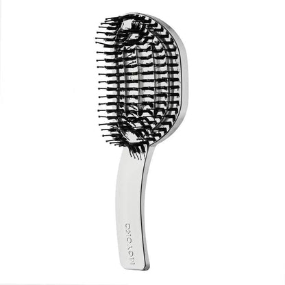 Oval-shaped Moyoko Hailo detangling brush with white handle and black bristles