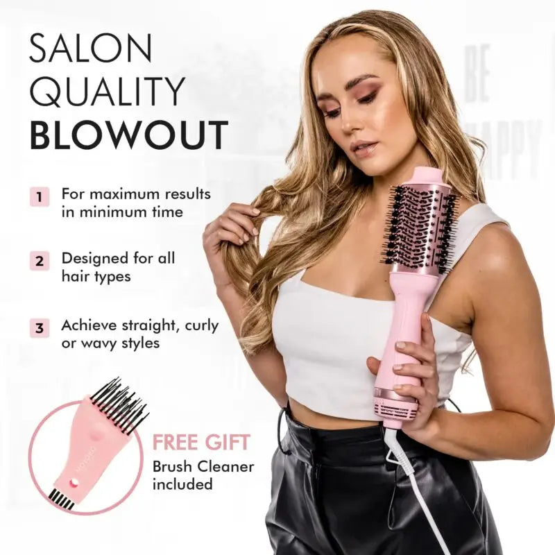 Pink and white electric hair styling brush held by a woman with long blonde hair.