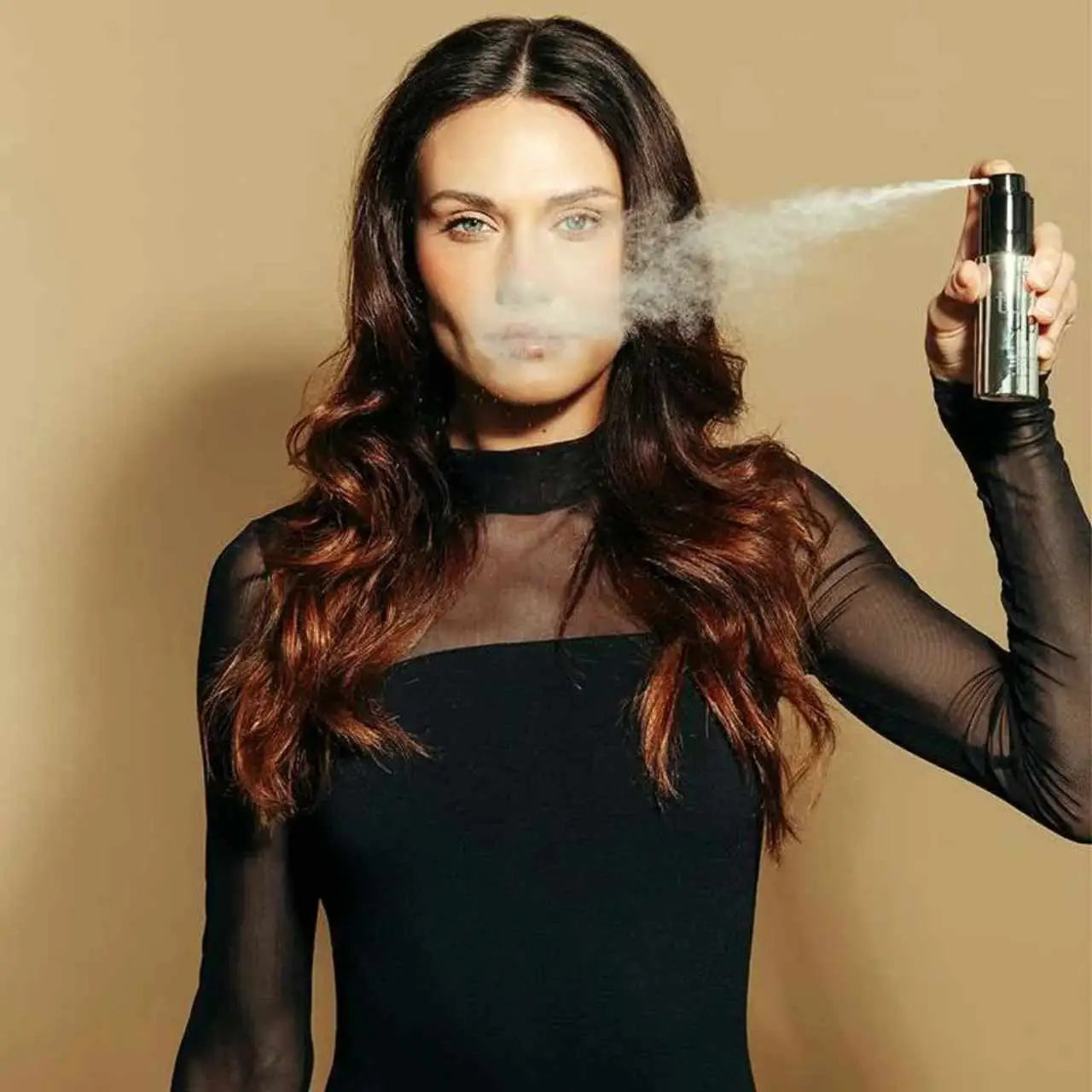 Person in black mesh-sleeved dress exhaling vapor, featuring Moyoko Turn Up Volume Powder 13g