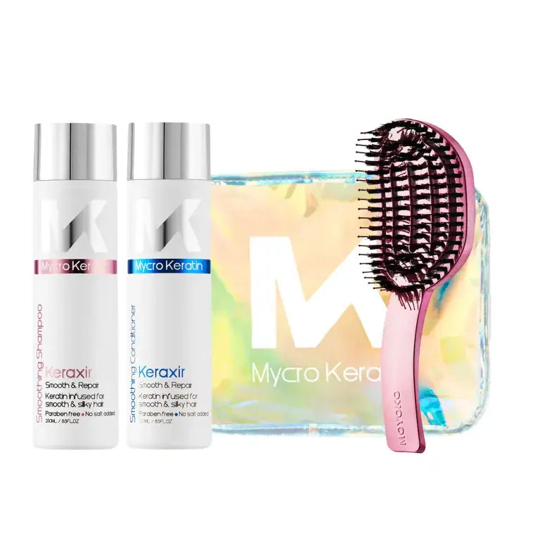 Hair care product set featuring two white bottles, a holographic pouch, and a pink detangling brush.