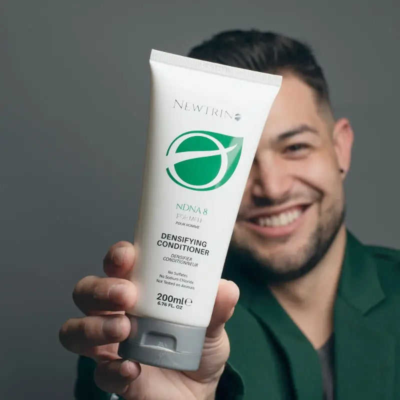 Smiling person holding Newtrino 200ml Men nDNA 8 Conditioner for oily scalp and sebum control