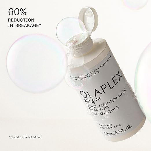 Olaplex No.4 Bond Maintenance Shampoo in a white bottle with a minimalist design and bubbles around it