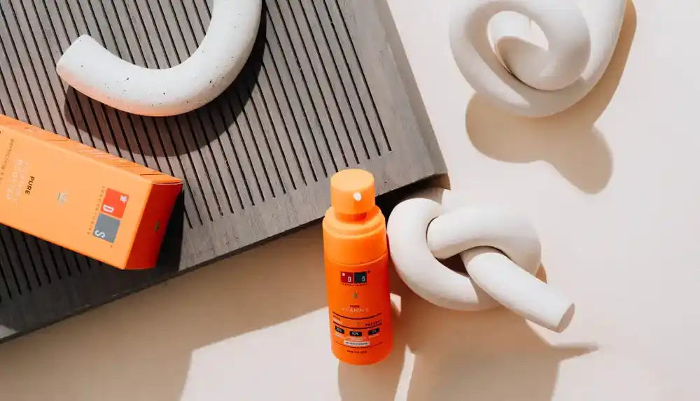 Orange sunscreen spray bottle.