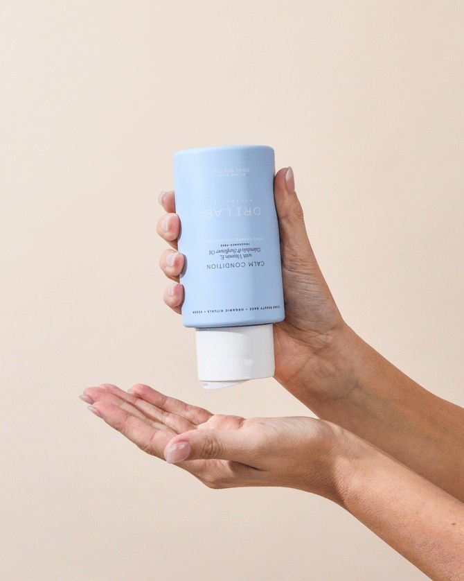 ORI Lab Calm Condition: Gentle Hair Conditioner for Sensitive Scalp. Hands holding the product.