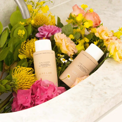 ORI LAB Curl Cleanse & Condition: Natural hair care products with floral arrangement. Vegan & cruelty-free, for defined curls.