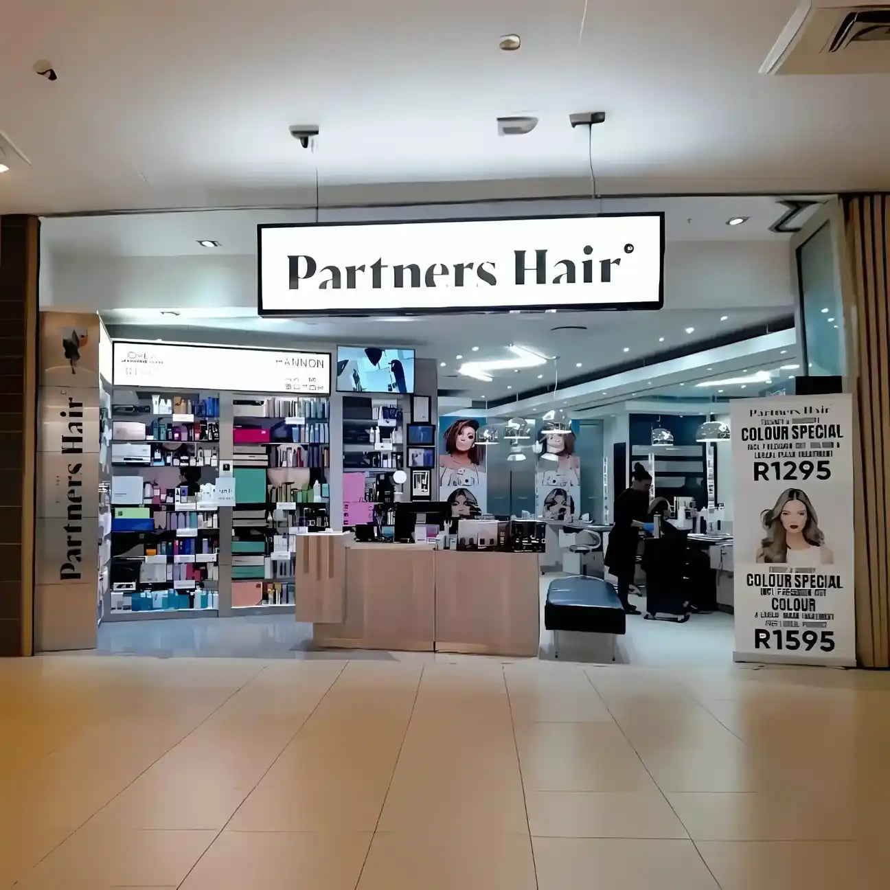 Partners Hair salon storefront with illuminated signage.