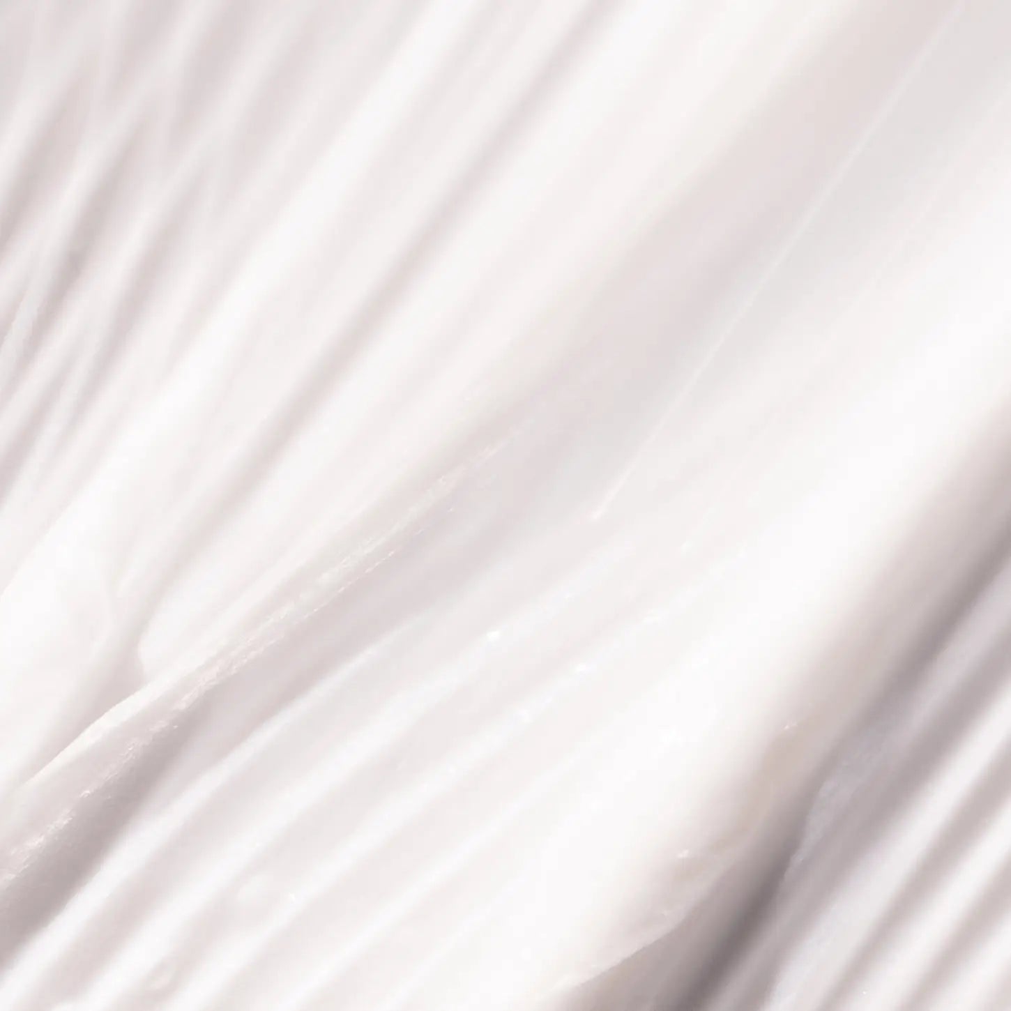 Smooth, flowing white fabric with gentle folds and creases.