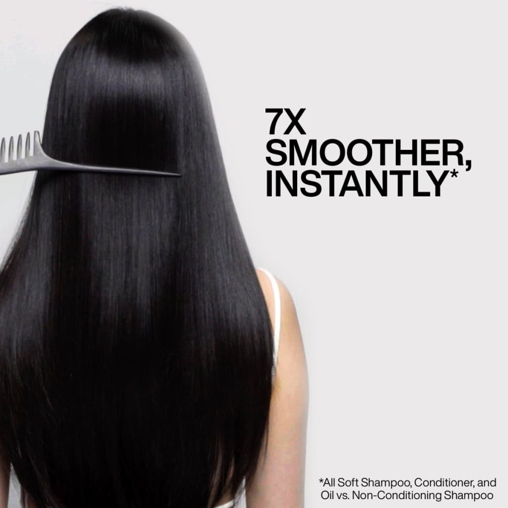 Combing long, shiny black hair with Redken All Soft Argan Oil for smooth, nourished locks