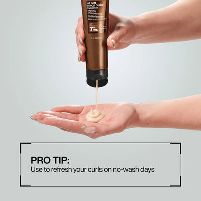 Redken All Soft Mega Curls Hydramelt Treatment for Curly Hair - Leave-in Conditioner being dispensed