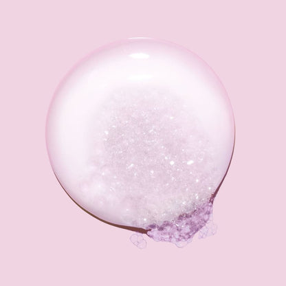 Translucent bubble with pinkish tinge and sparkles showing Redken Volume Injection Shampoo