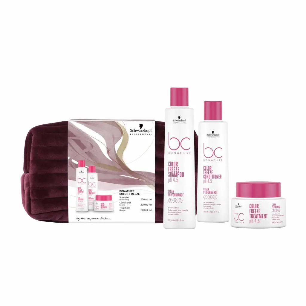 Hair care product set with pink and white bottles and a purple cosmetic bag.