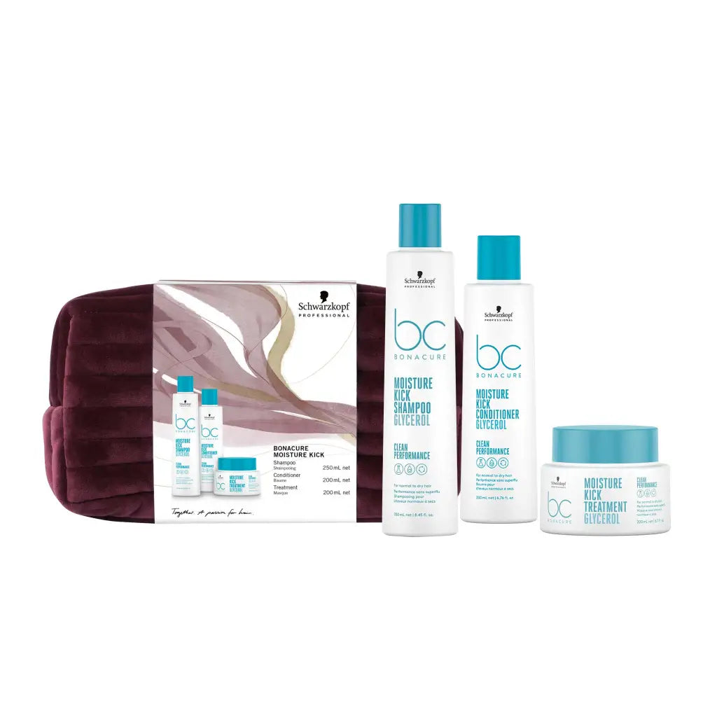 Hair care product gift set featuring shampoo, conditioner, and treatment in teal and white packaging with a burgundy cosmetic bag.