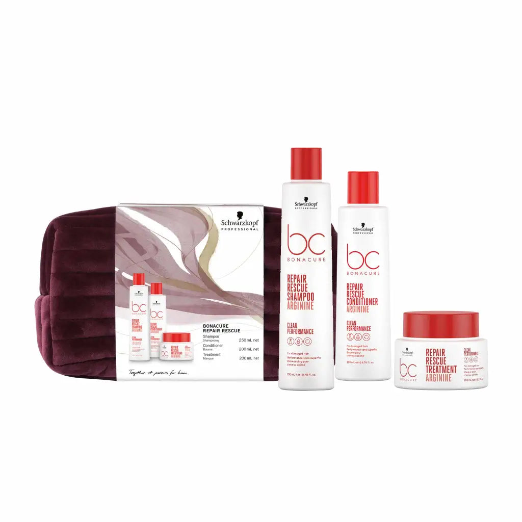 Hair care product set featuring shampoo, conditioner, and treatment in a burgundy travel bag.