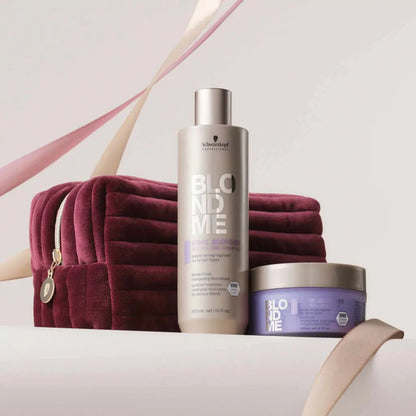 Hair care products displayed with a burgundy velvet cosmetic bag.