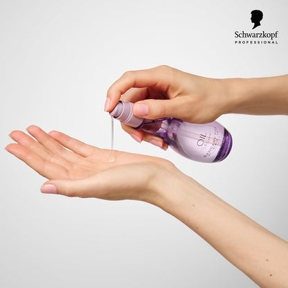 Schwarzkopf Professional Oil Ultime Barbary Fig Finishing Oil - 100ml being applied for luxurious hair pampering.