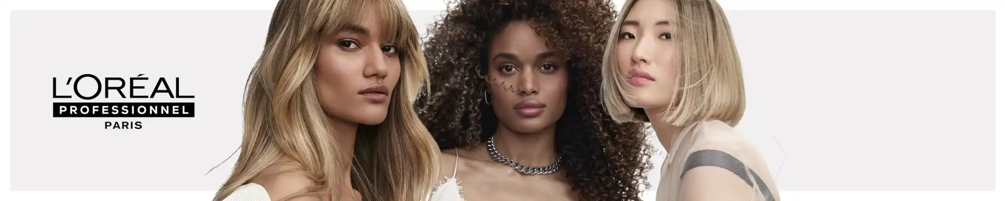 Three women with diverse hair types and styles posing together.