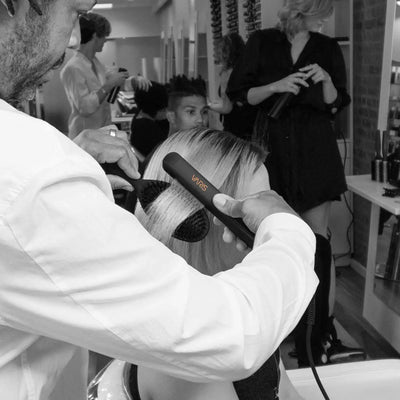 Varis Smoother in Salon: Hair Stylist Using Ceramic Flat Iron for Sleek Hair Styling