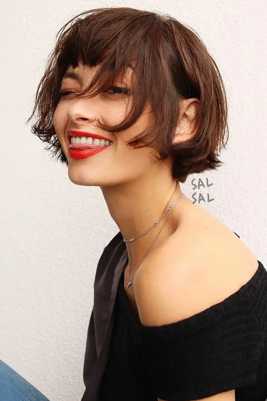 Smiling woman with short dark hair and bright red lipstick.